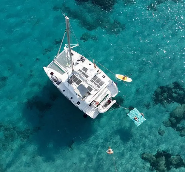A catamaran sailing in clear blue water